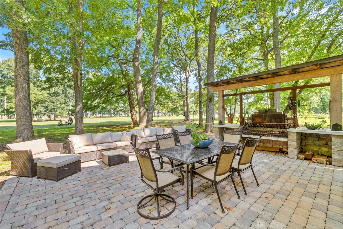 Outdoor lounge seating under mature trees